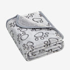 Folded gray dog blanket with black paw prints