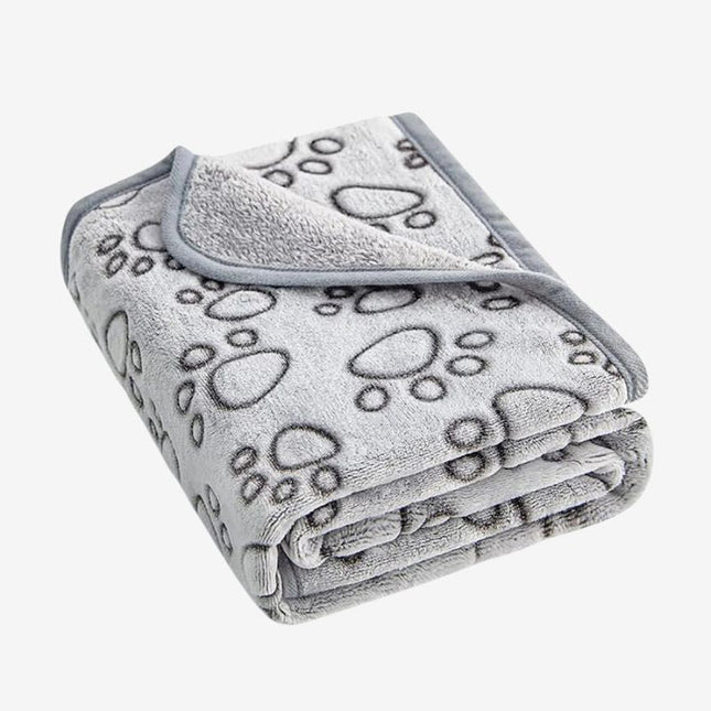 Folded gray dog blanket with black paw prints