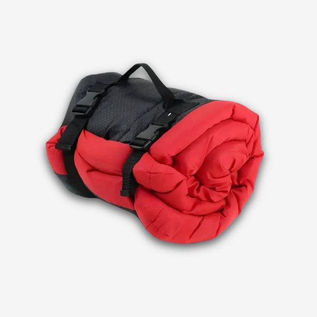 Red waterproof dog travel bed rolled up with carry strap