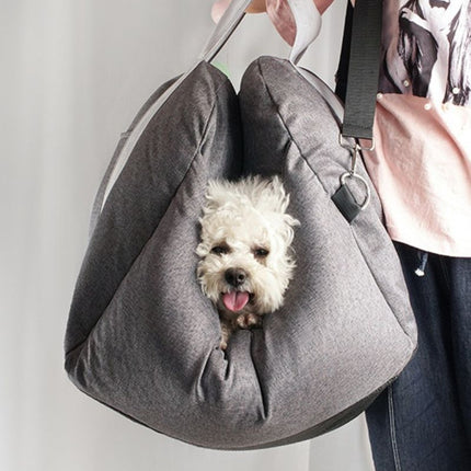 Small dog in dog car seat carrier for safe travels