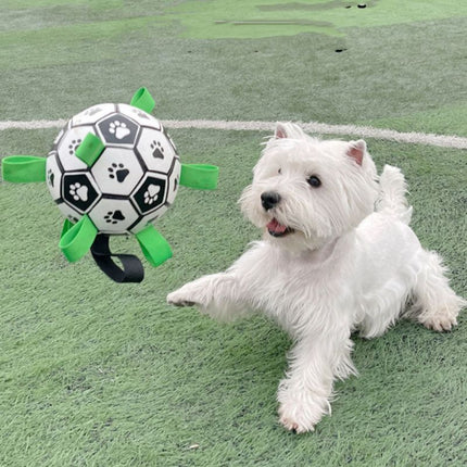 White dog chasing RuffPlay ball on artificial turf