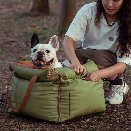 Woman zipping open luxury dog car seat for Bulldog in outdoor adventure