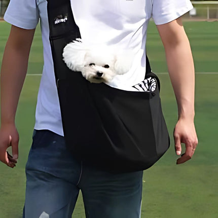 small dog carrier with white puppy in black sling